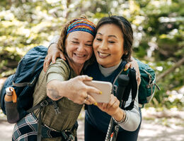 Two older women smiling and taking a selfie.