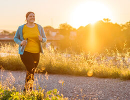 A woman jogs outdoors.